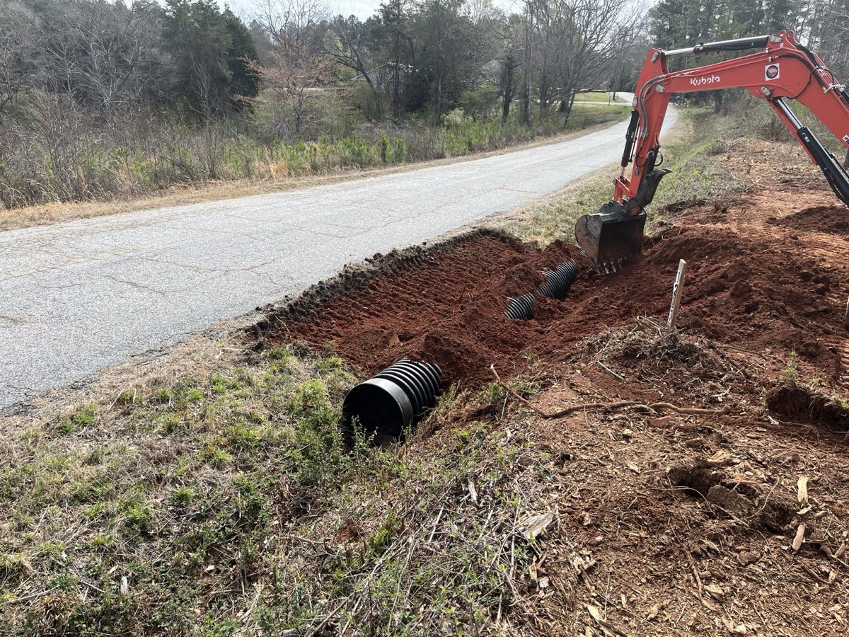 Compact Kubota excavator installing a driveway culvert in Pickens, SC